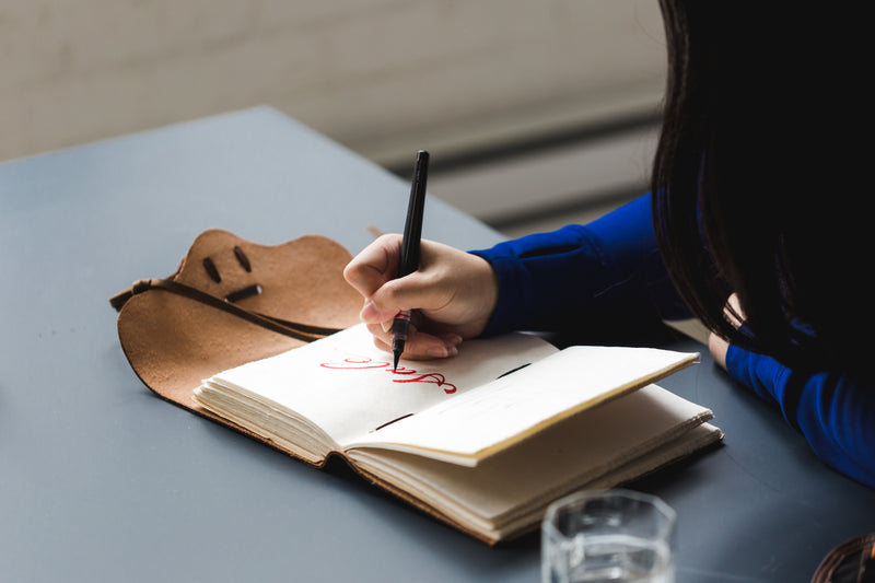 artist writing sale in notebook