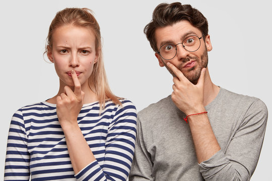 Portrait of male and female students have puzzled serious expressions, think how to make good presen