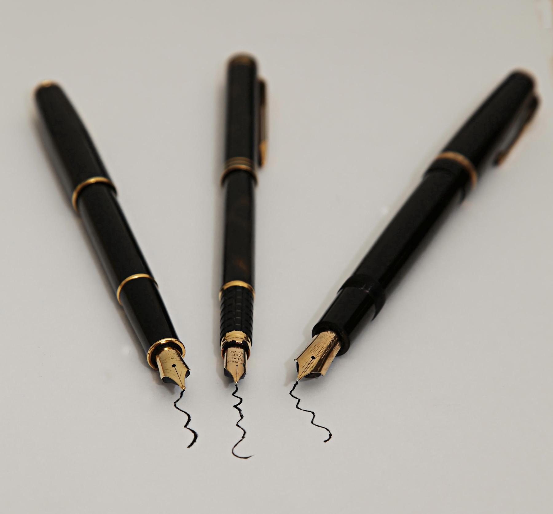 three black pens and a pen on a white background - File:The write thing Project 365(2) Day 12 (43557